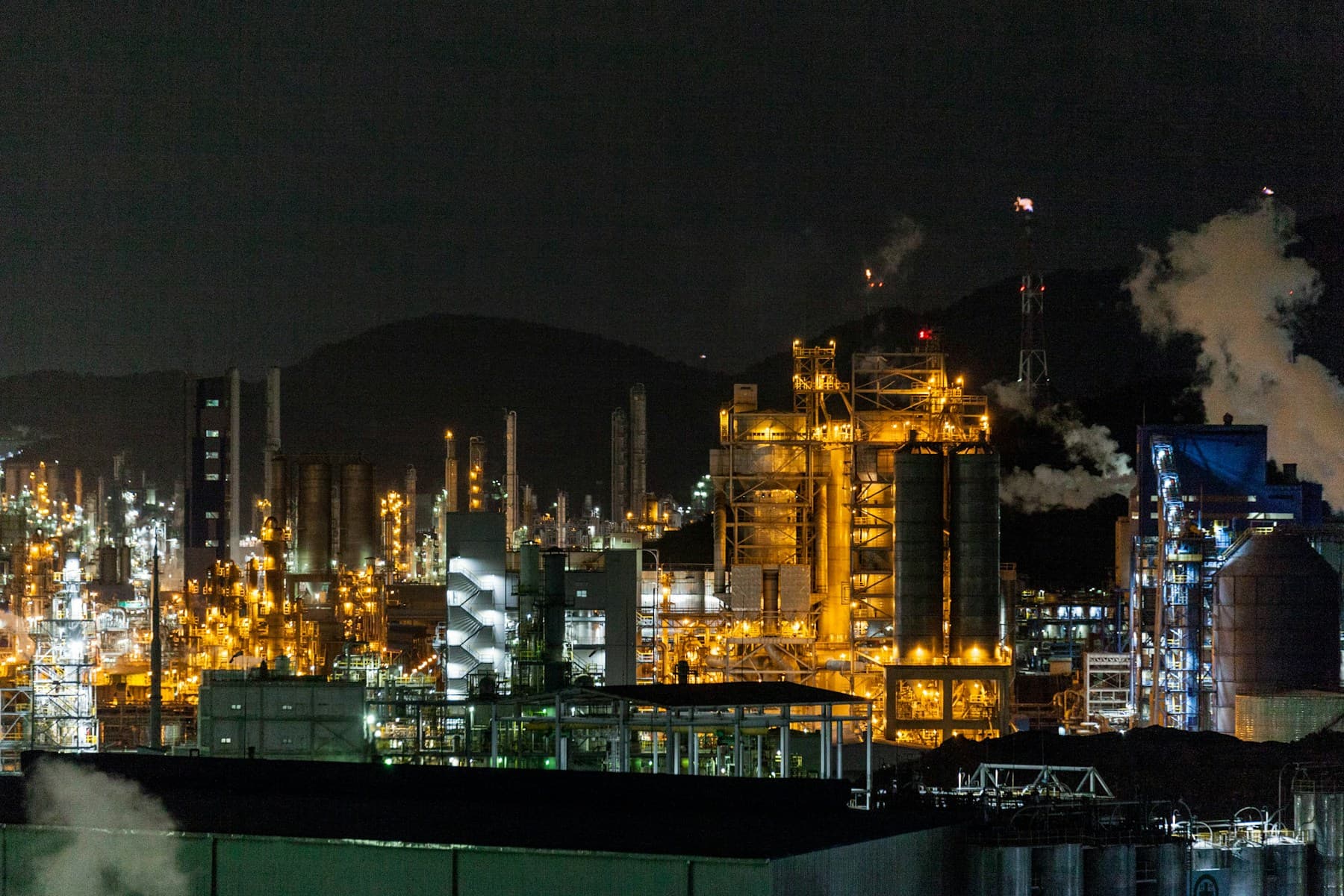 Oil pump jack silhouette against red sunset
